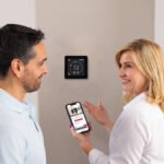 Homeowner discussing an AC running constantly with an HVAC technician near a thermostat