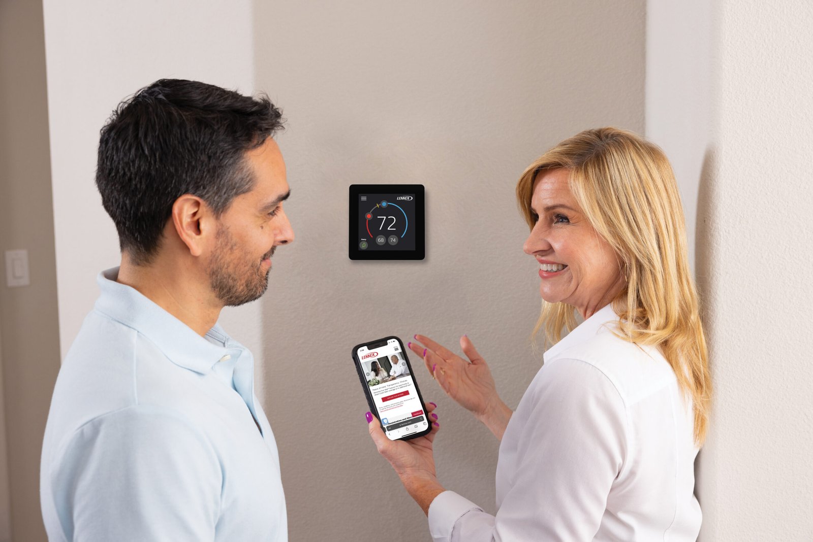 Homeowner discussing an AC running constantly with an HVAC technician near a thermostat